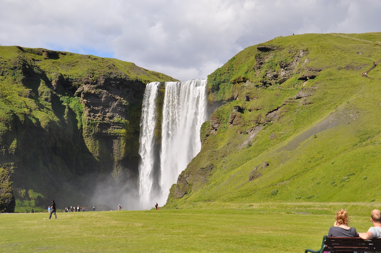 a waterfall in a grassy area